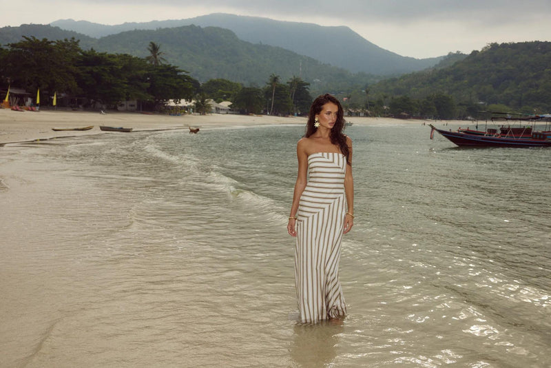 Woman in maxi dress on island beach